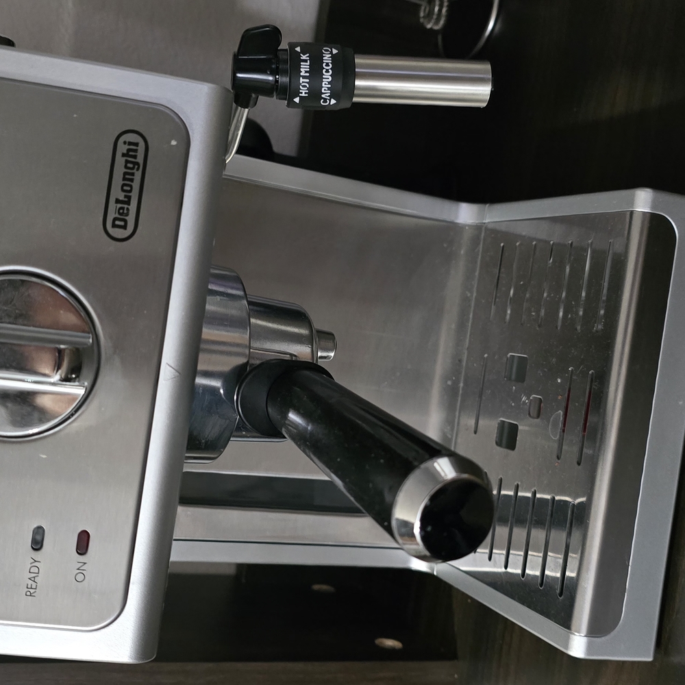 Sleek Silver and Black Coffee Machine with Professional-Grade Features
